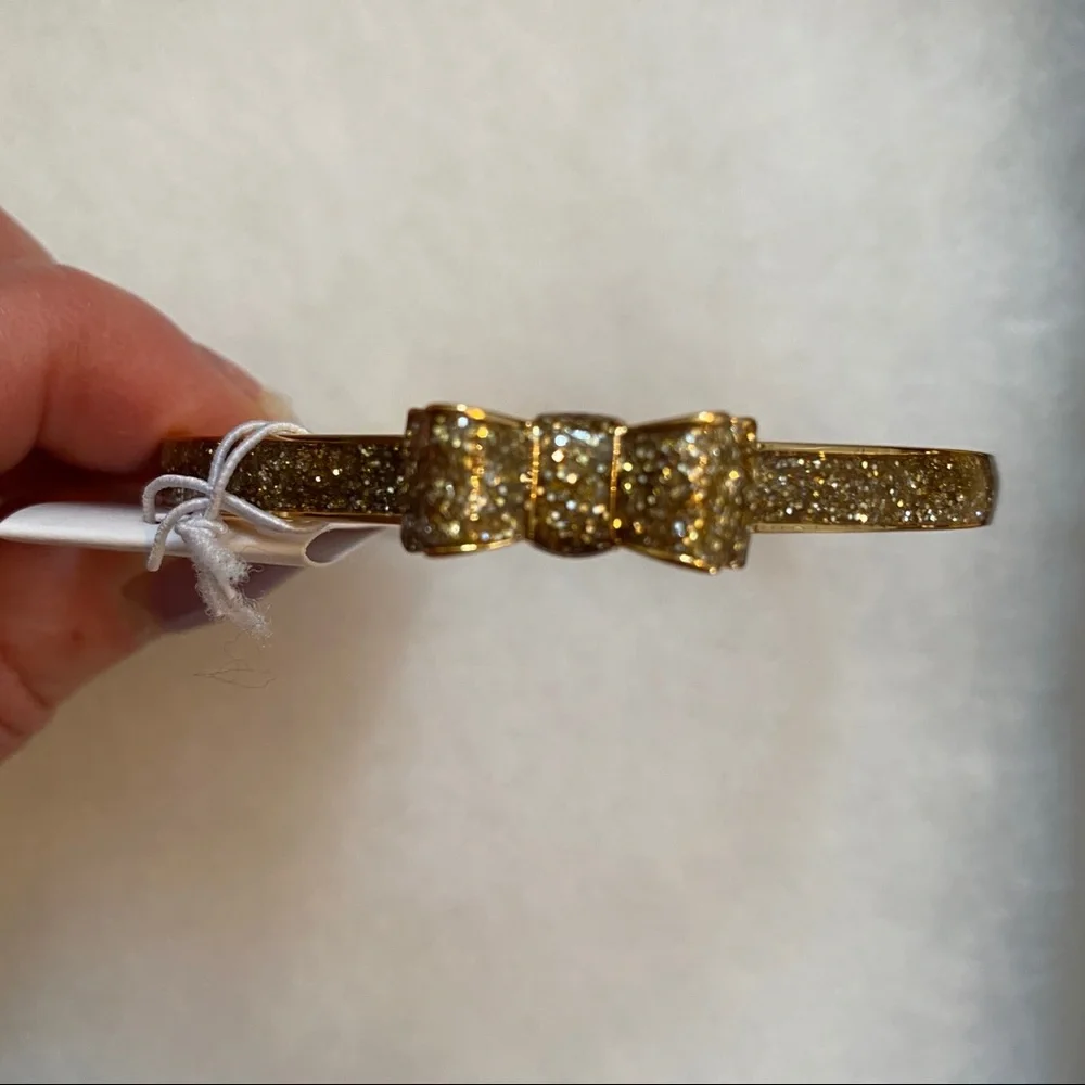 KATE SPADE NEW NWT BRACELET BANGLE GOLD PLATE GLITTER BOW MOON RIVER JEWELRY - Picture 1 of 7